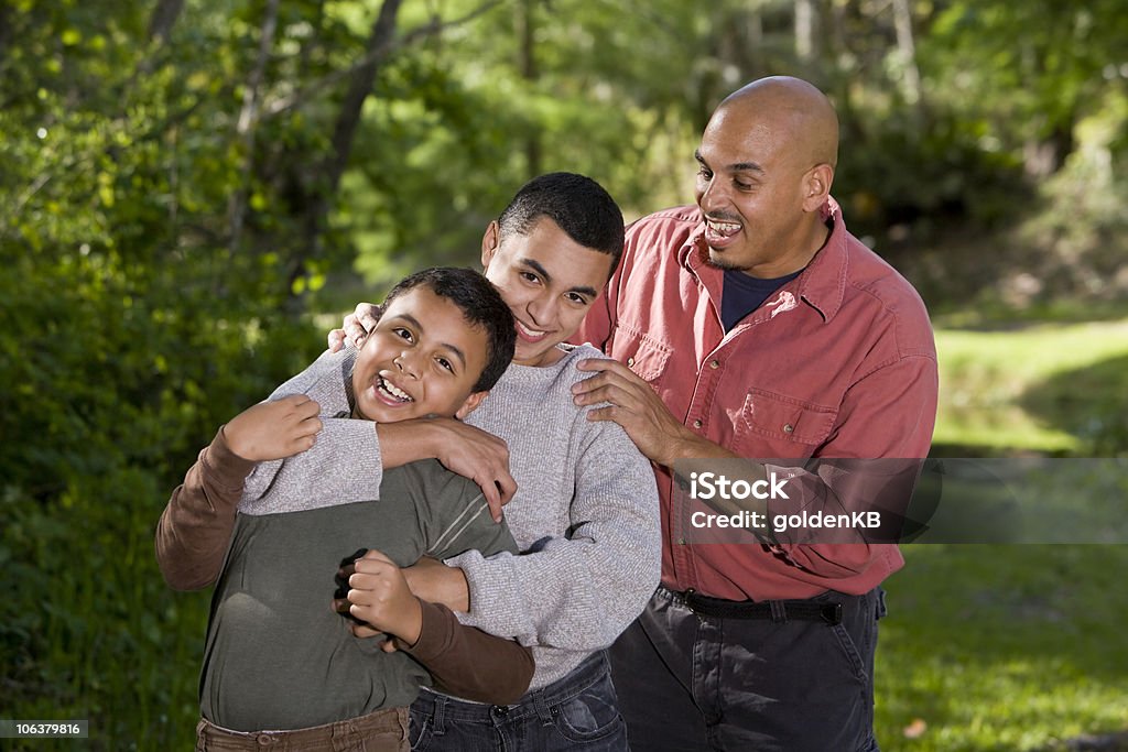 Portrait of Hispanic family with two boys outdoors  Parent Stock Photo