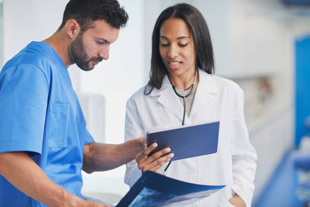 istock Dentist office, looking at x-ray images. 1063799668