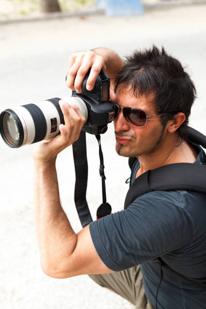 istock Handsome photographer takes a picture 1063803182