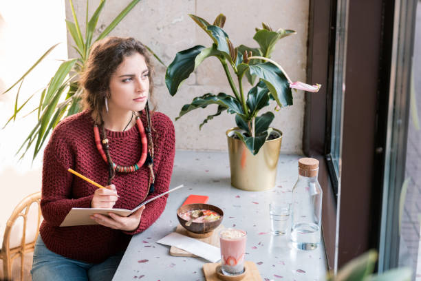 istock Creative inspired artist drawing some sketches having breakfast in cafeteria 1063807928