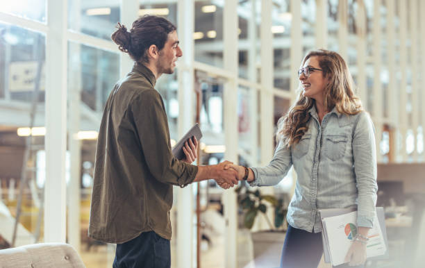 istock Business partners greeting each other in office 1063811690