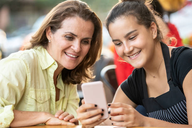 istock Smiling women looking at a smart phone 1063811886