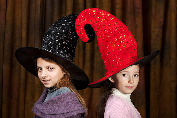 Two happy friends witches outdoor, smiling preparing for halloween party
