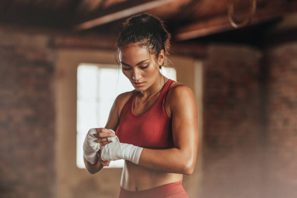 istock Female boxer wearing strap on wrist 1063813164