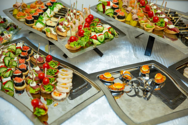 istock Catering table set service various snacks on a table at banquet. Set of cold snacks, canape, beverages, closeup. Side view. 1063813772