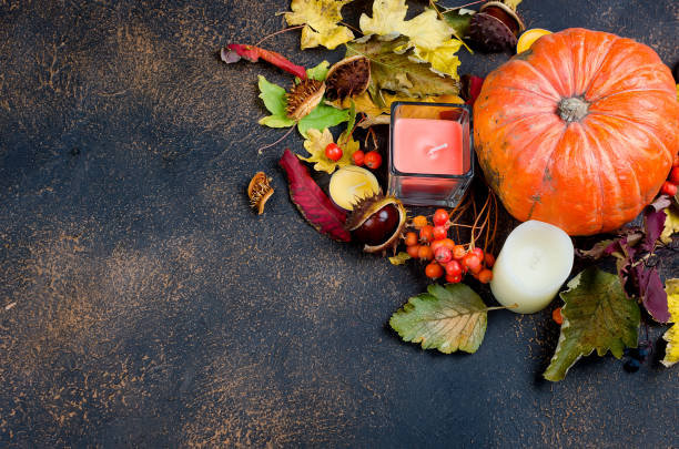 istock autumn leaves, pumpkin, chestnuts, candles on a dark background 1063814120