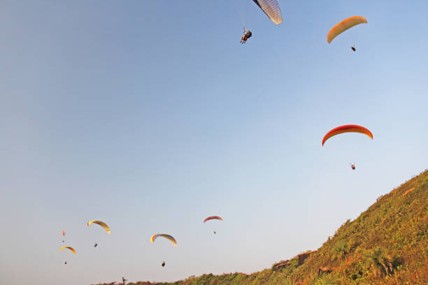 istock Paragliders against the blue sky. Bright paragliders fly in the 1063815052