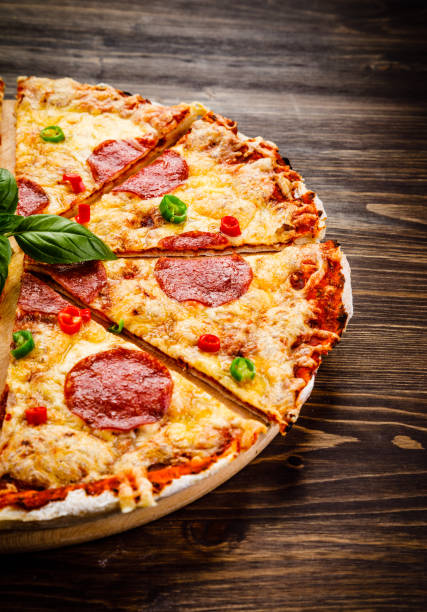 istock Pizza pepperoni on wooden background 1063818182