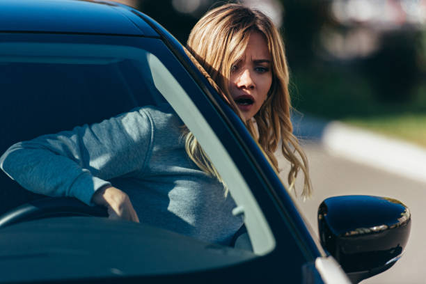 istock young shocked woman leaning out car window while driving car 1063818722