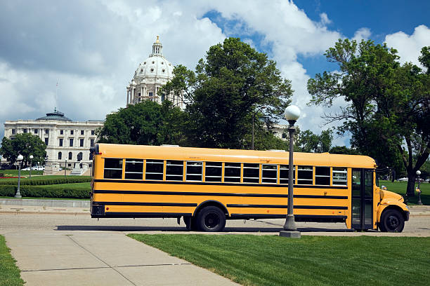 Yellow school bus parked on green grass