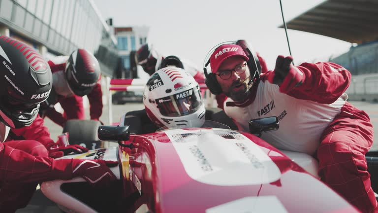 Coach instructing racer at pit stop