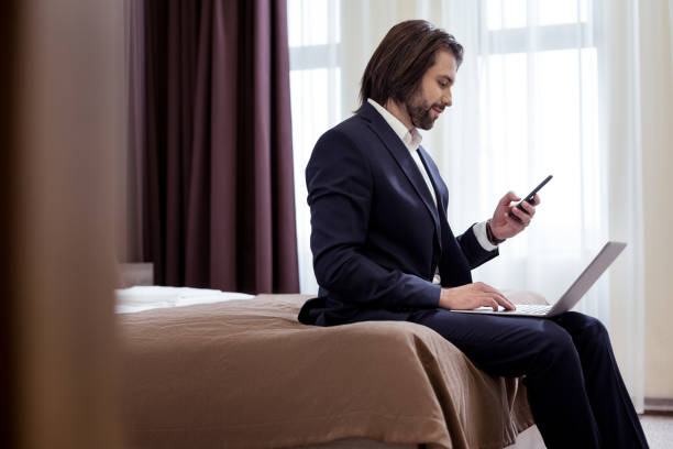 istock Smart handsome businessman using his mobile phone 1063822430