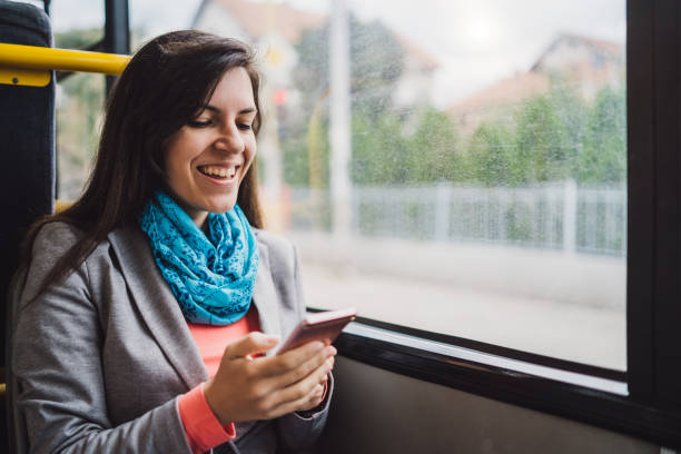 istock Young woman using phone on a city bus ride 1063822500
