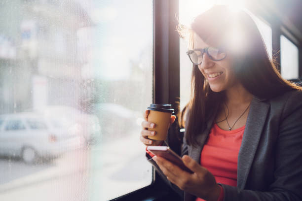 istock Young woman using phone on a city bus ride 1063822786