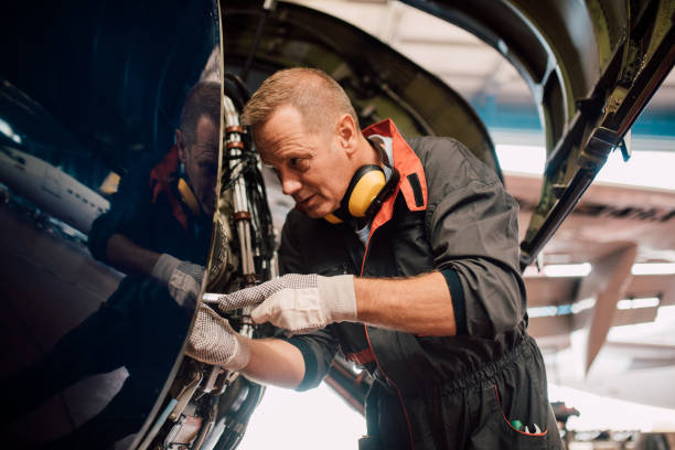 istock Older mechanic fixing aircraft 1063826040