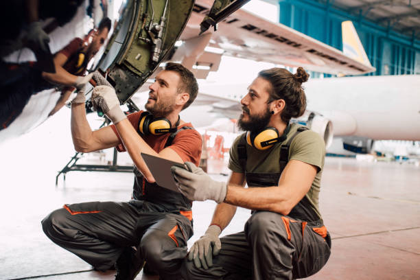 istock Men with digital tablet fixing aircraft 1063827278