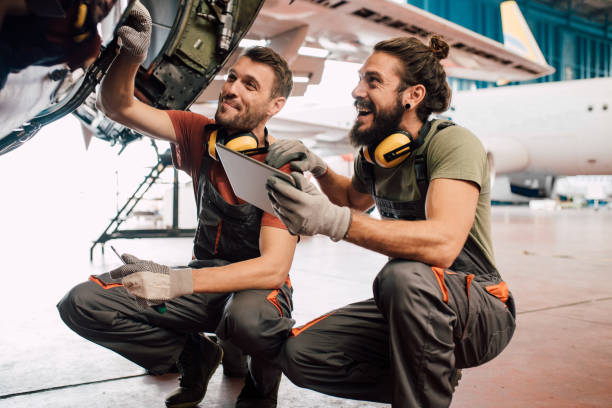 istock Happy men with digital tablet fixing aircraft 1063827388
