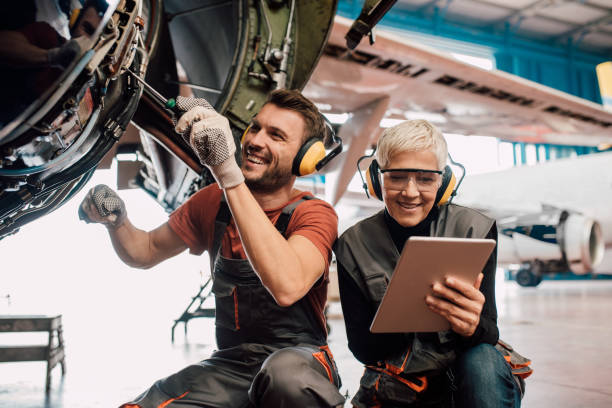 istock Mechanic team with digital tablet repairing aircraft 1063828552