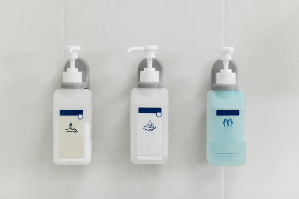 liquid soap dispensers on the gray wall.