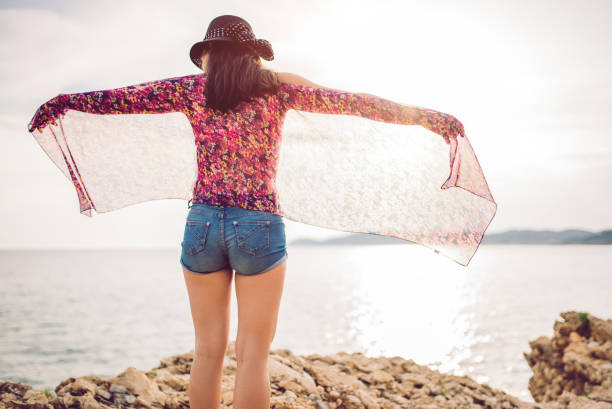istock Young woman on the rocky beach 1063828846