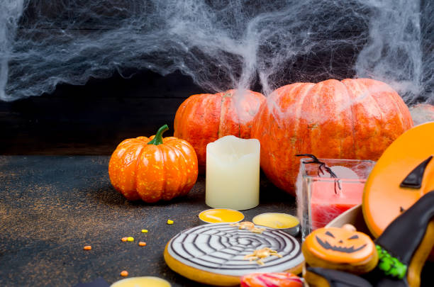 istock Halloween background with gingerbread, pumpkins and candles 1063829964