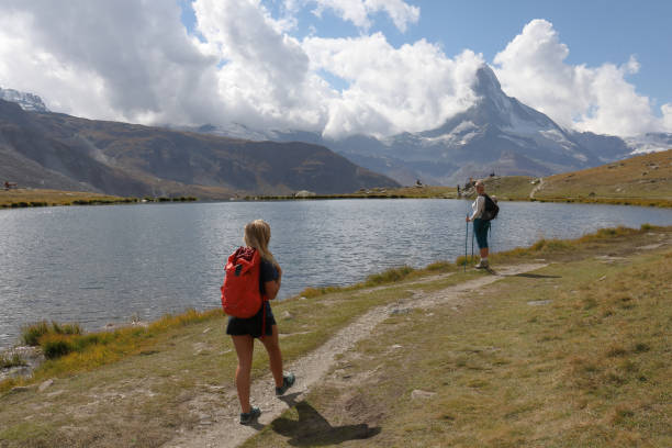 istock Female hikers walk along lakeshore 1063833344
