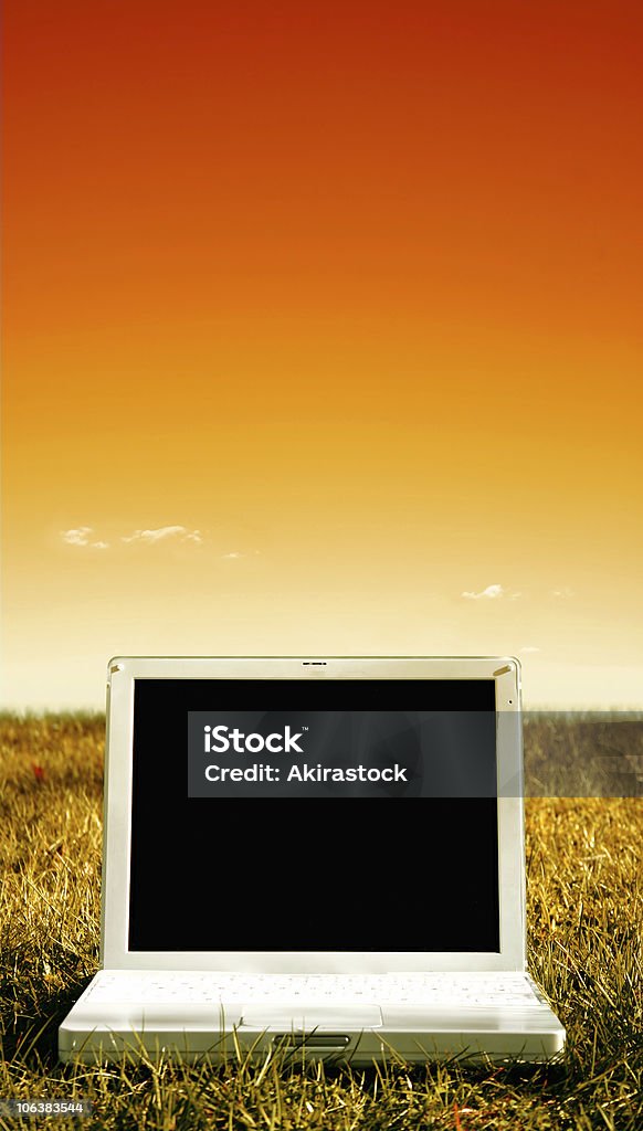 Laptop in sunset  Agricultural Field Stock Photo