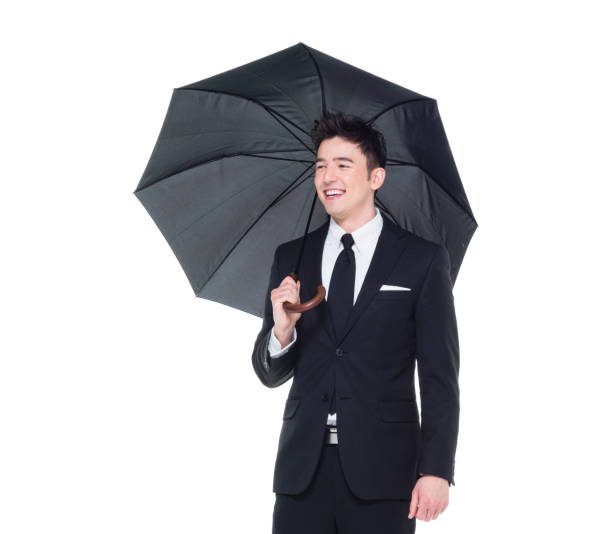 istock Handsome businessman holding an umbrella 1063835662