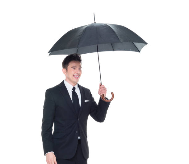 istock Handsome businessman holding an umbrella 1063835676