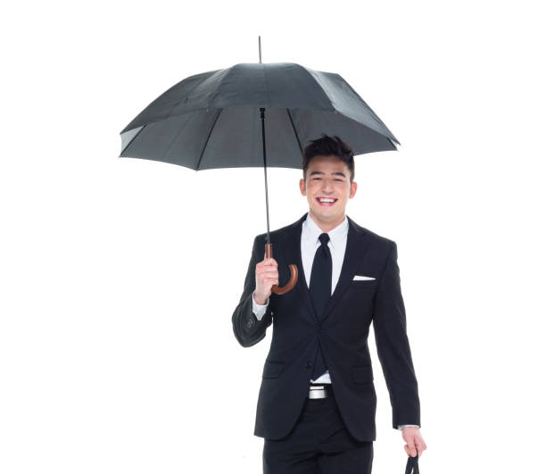 istock Handsome businessman holding an umbrella 1063835844