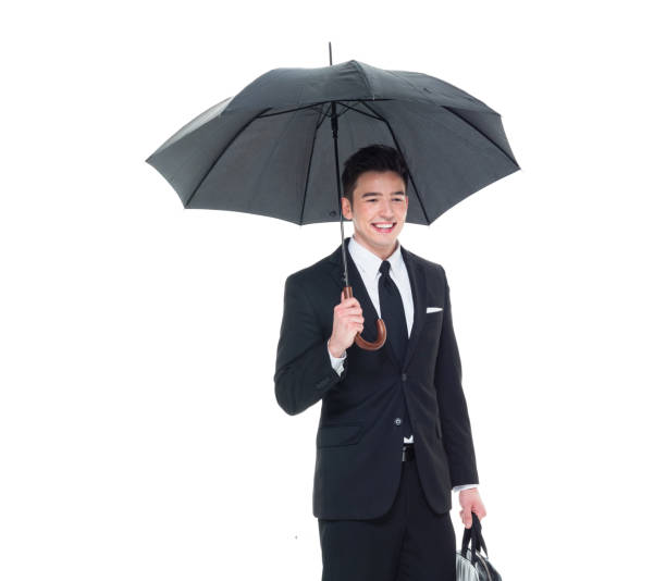 istock Handsome businessman holding an umbrella 1063835898