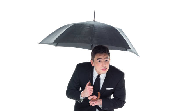 istock Handsome businessman holding an umbrella 1063835906