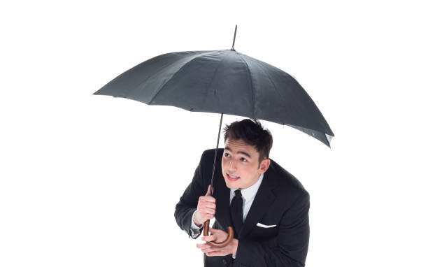 istock Handsome businessman holding an umbrella 1063835976