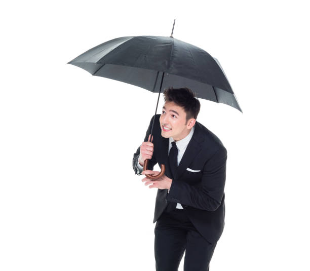 istock Handsome businessman holding an umbrella 1063835986