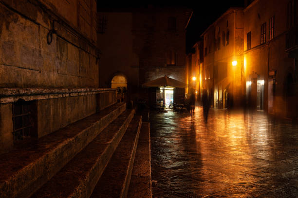 istock Old European illuminated street at rainy night 1063837306