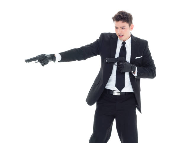 istock Handsome businessman holding a handgun 1063837556