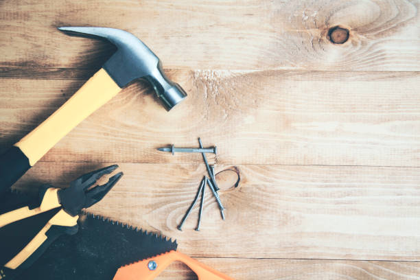 istock hammer and nail on old wooden table 1063840174