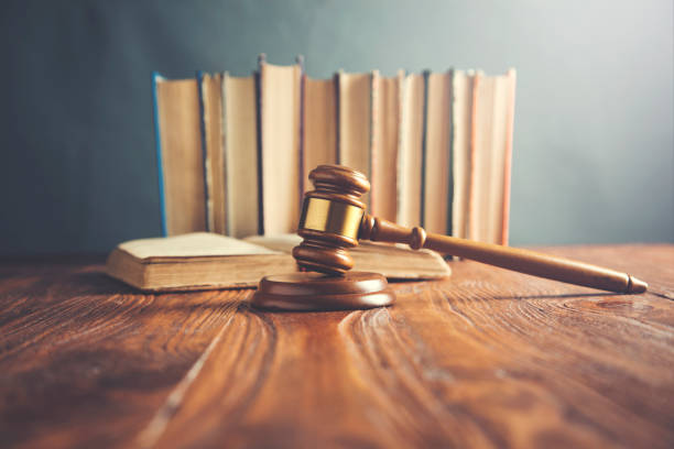 istock hammer with books on wooden table 1063840420