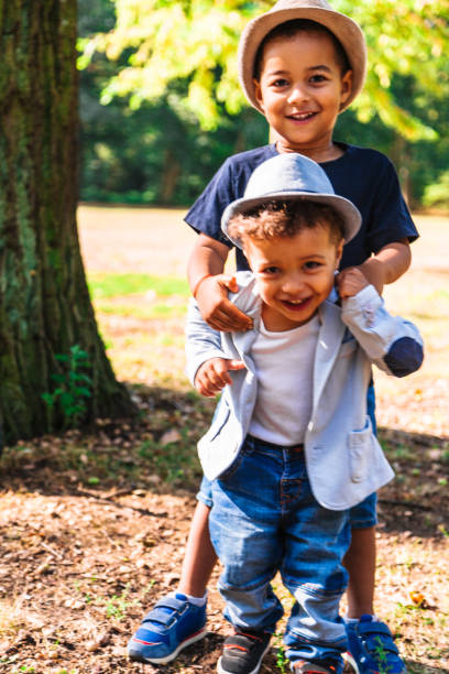 istock Two happy brothers fooling around and playing in nature 1063841136