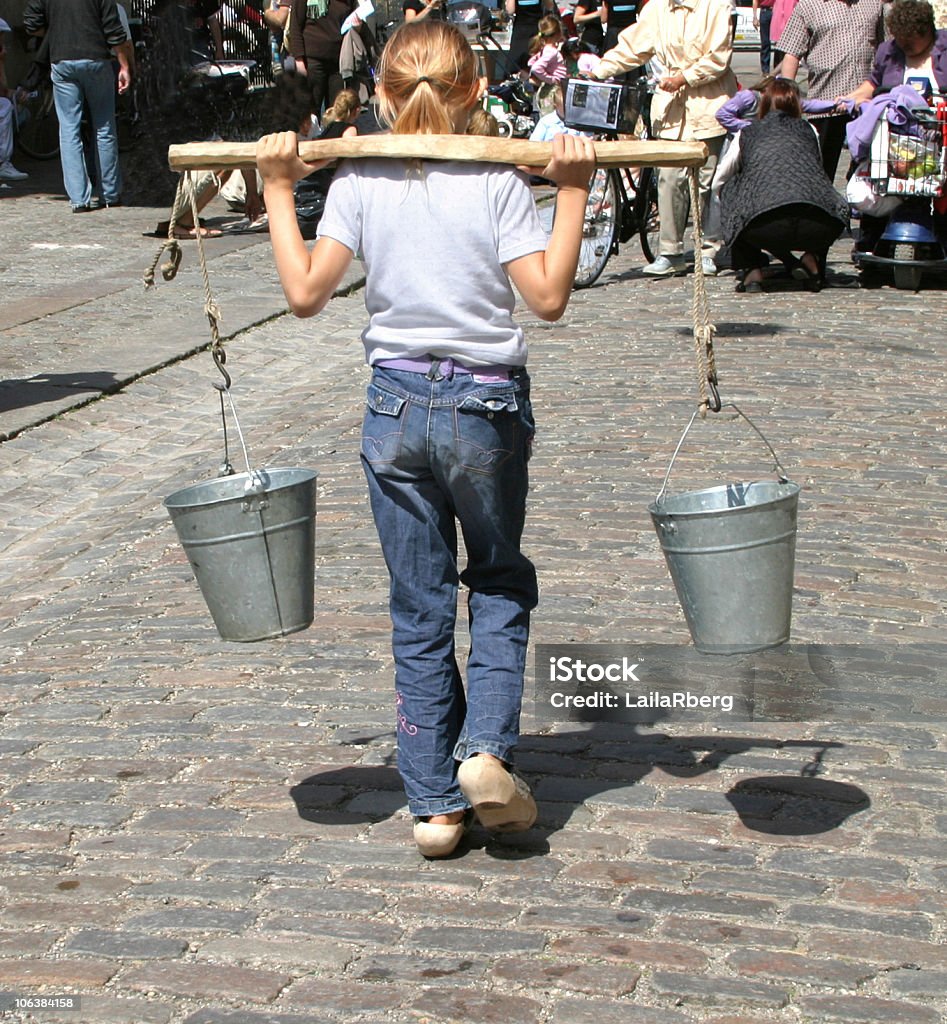 Child carrying water  Water Stock Photo