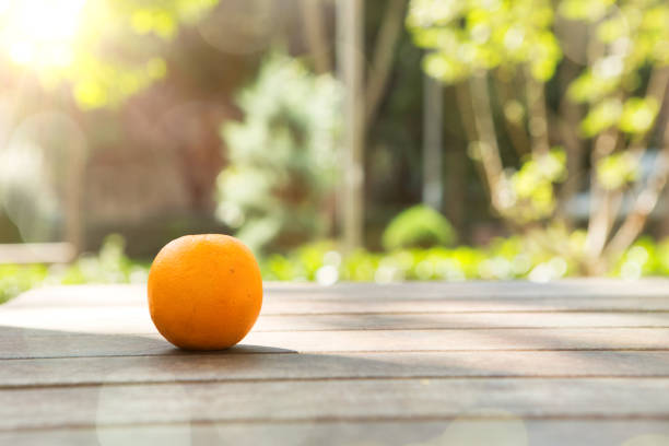 Funny fruit and vegetables with eyes on wooden table in public park.Cute food with faces.Funny fruit characters.