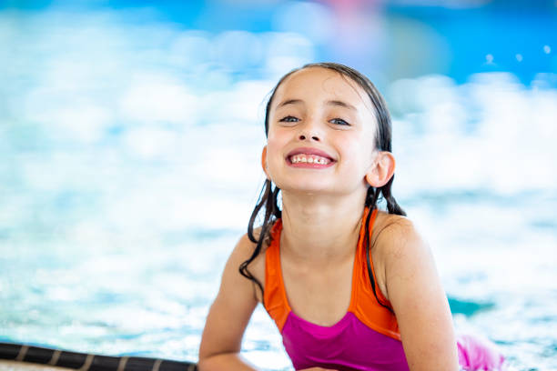 istock Smiling girl in the pool 1063846740