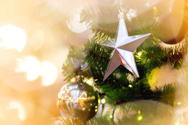 istock Fir tree decorated with shiny balls, star and light bulbs for Christmas and New Year celebration. 1063855014