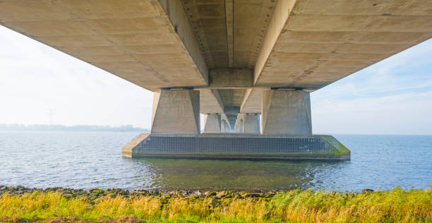 istock Bridge over a lake in sunlight at fall 1063855378