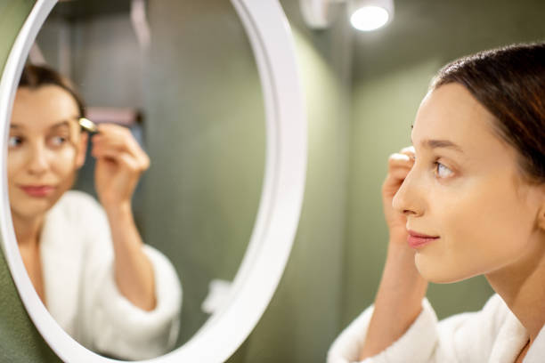 istock Woman painting eyebrows 1063865268