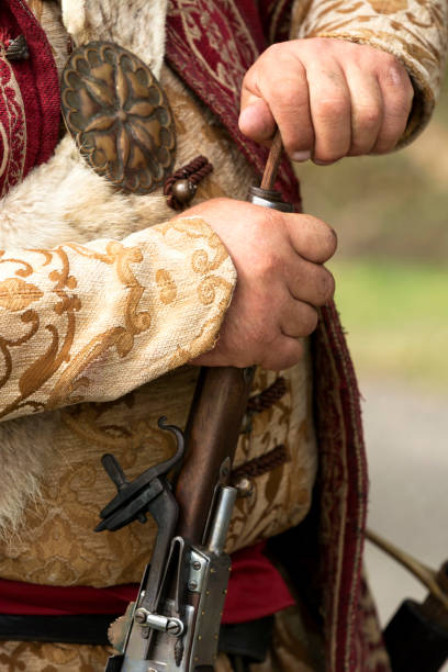 istock Aged weapon and soldier dress 1063865436