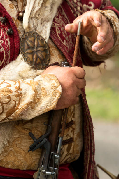 istock Aged weapon and soldier dress 1063865960