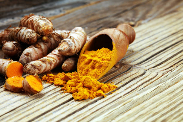istock Turmeric powder and fresh turmeric on grey background 1063869124