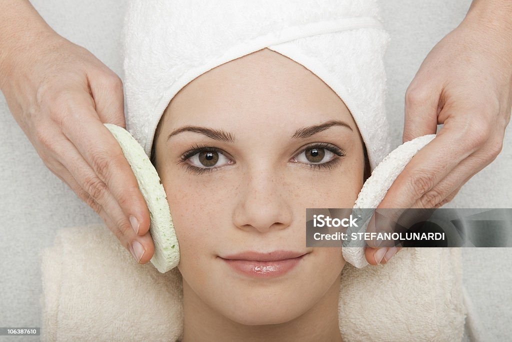 Face Cleansing Young woman receiving face cleansing at beauty spa 20-29 Years Stock Photo