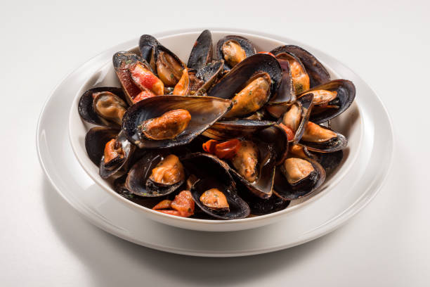 istock Bowl with cooked and open mussels 1063878908